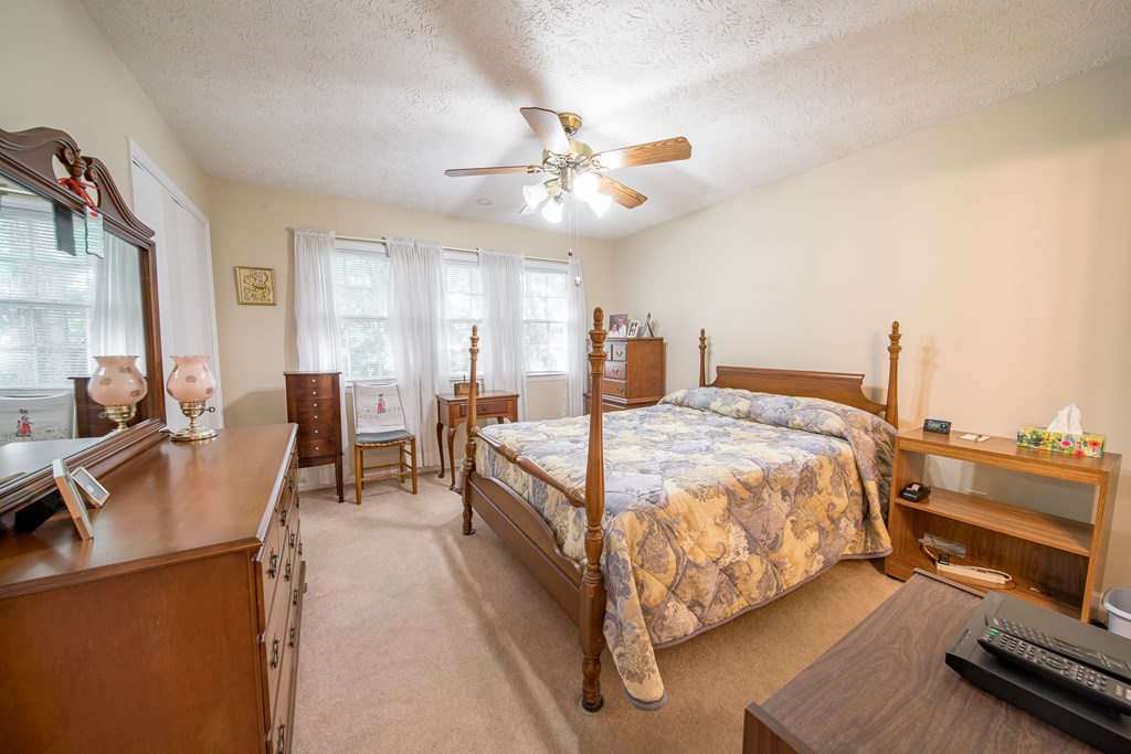 6101 River Road, Unit 42 Columbus, GA 31904 - Photo 19 of 28 a bedroom with a bed couch and a view of dining room