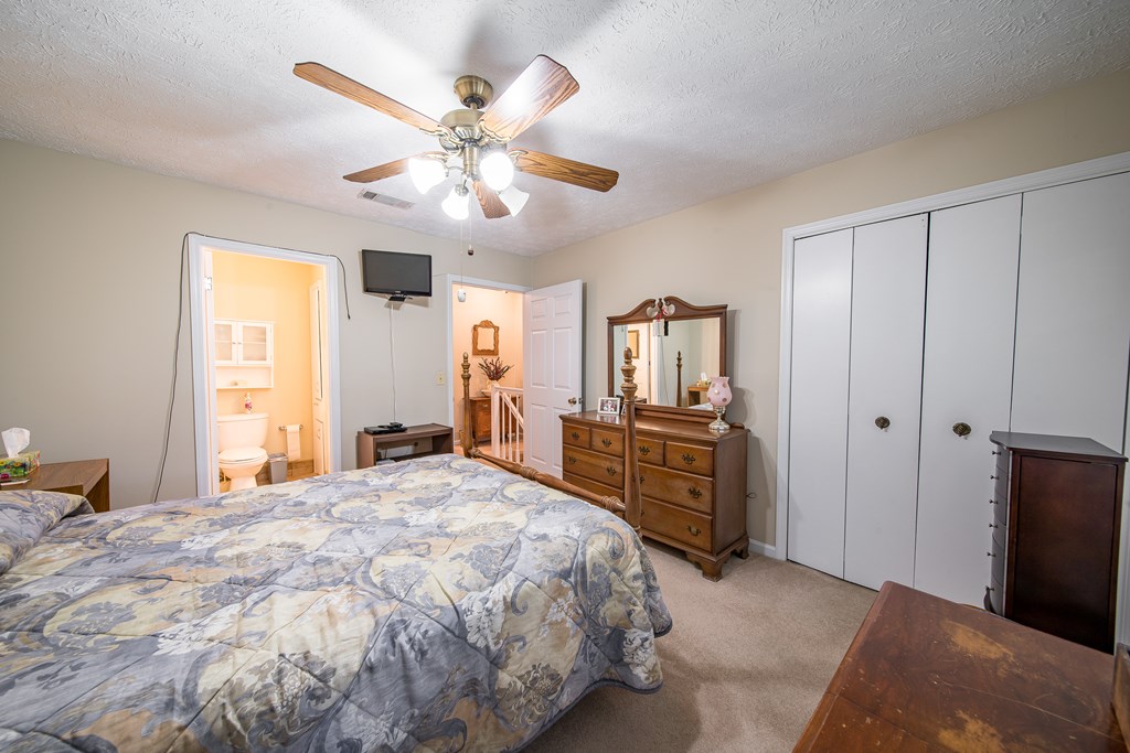 6101 River Road, Unit 42 Columbus, GA 31904 - Photo 20 of 28 a bedroom with a large bed and a chandelier