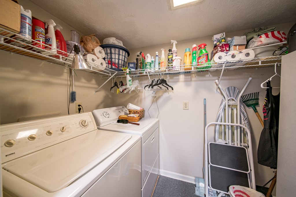 6101 River Road, Unit 42 Columbus, GA 31904 - Photo 22 of 28 a utility room with dryer washer and a view of living room