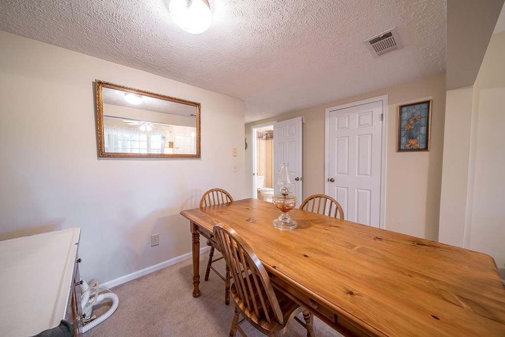6101 River Road, Unit 42 Columbus, GA 31904 - Photo 8 of 28 a room with a table chairs and wooden floor