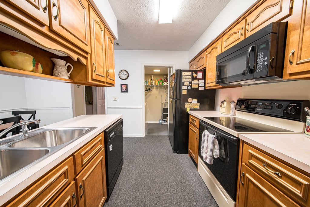 6101 River Road, Unit 42 Columbus, GA 31904 - Photo 9 of 28 a kitchen with stainless steel appliances granite countertop a stove and a sink