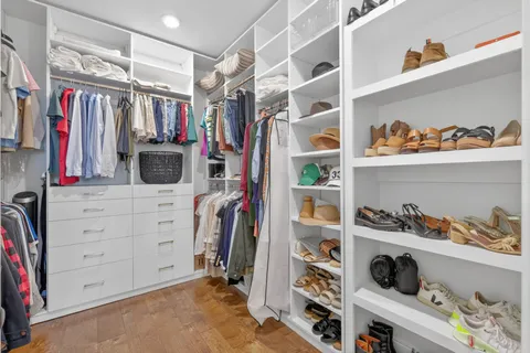 a kitchen with stainless steel appliances granite countertop a stove a sink a dining table and chairs