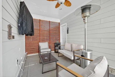 a living room with stainless steel appliances kitchen island granite countertop a sink and cabinets