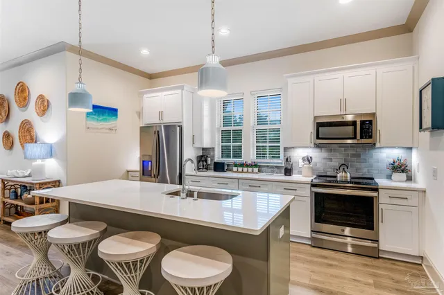 a kitchen with a stove a sink and a refrigerator