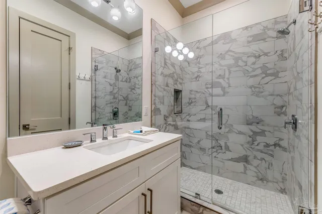 a bathroom with a sink a mirror and shower