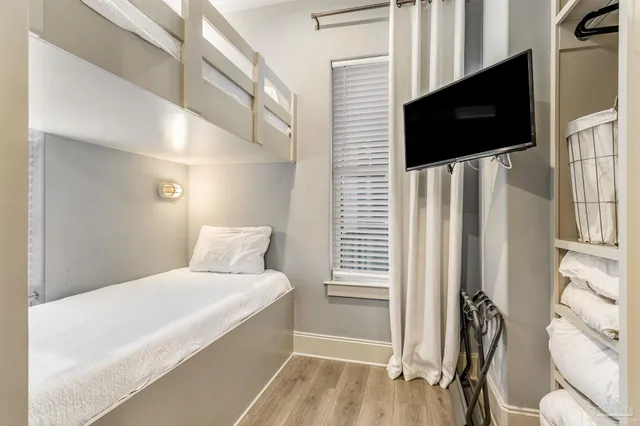 a bathroom with a bathtub and a flat screen tv