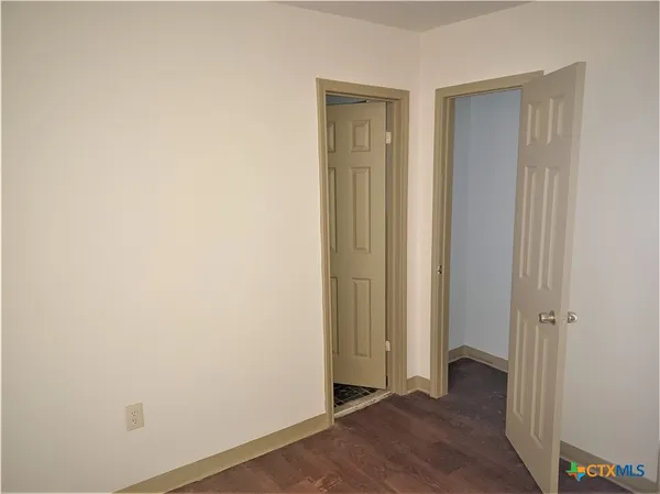 an empty room with wooden floor