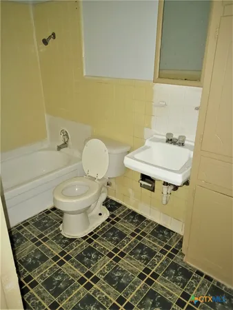 a bathroom with a toilet and a sink