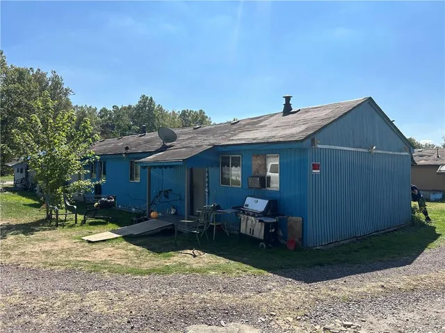 a view of a house with a yard siting area and garden