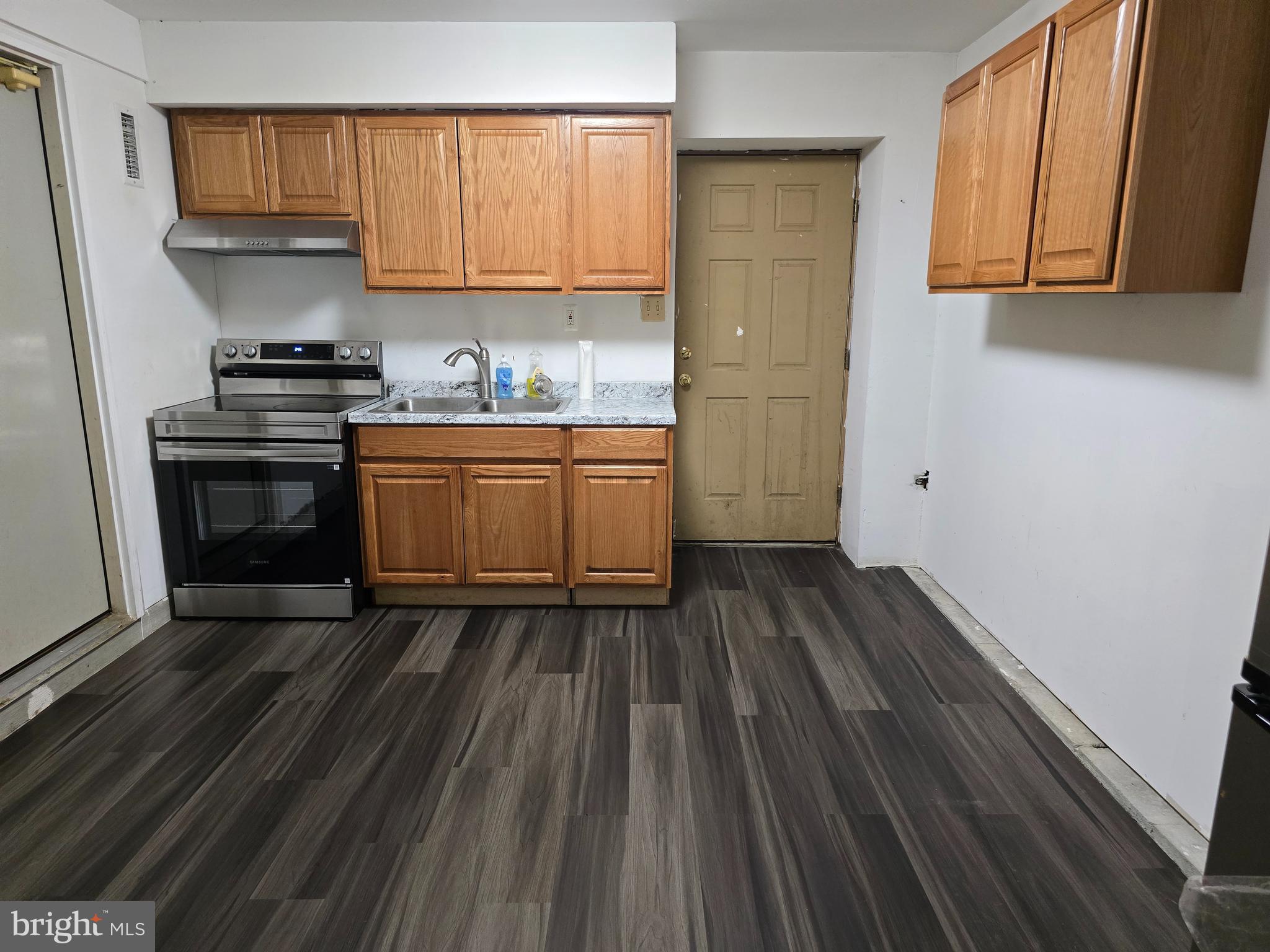 9503 Hallhurst Road Nottingham, MD 21236 - Photo 16 of 17 a kitchen with sink a microwave and cabinets