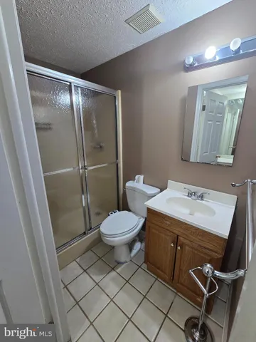 a bathroom with a toilet a sink and a mirror
