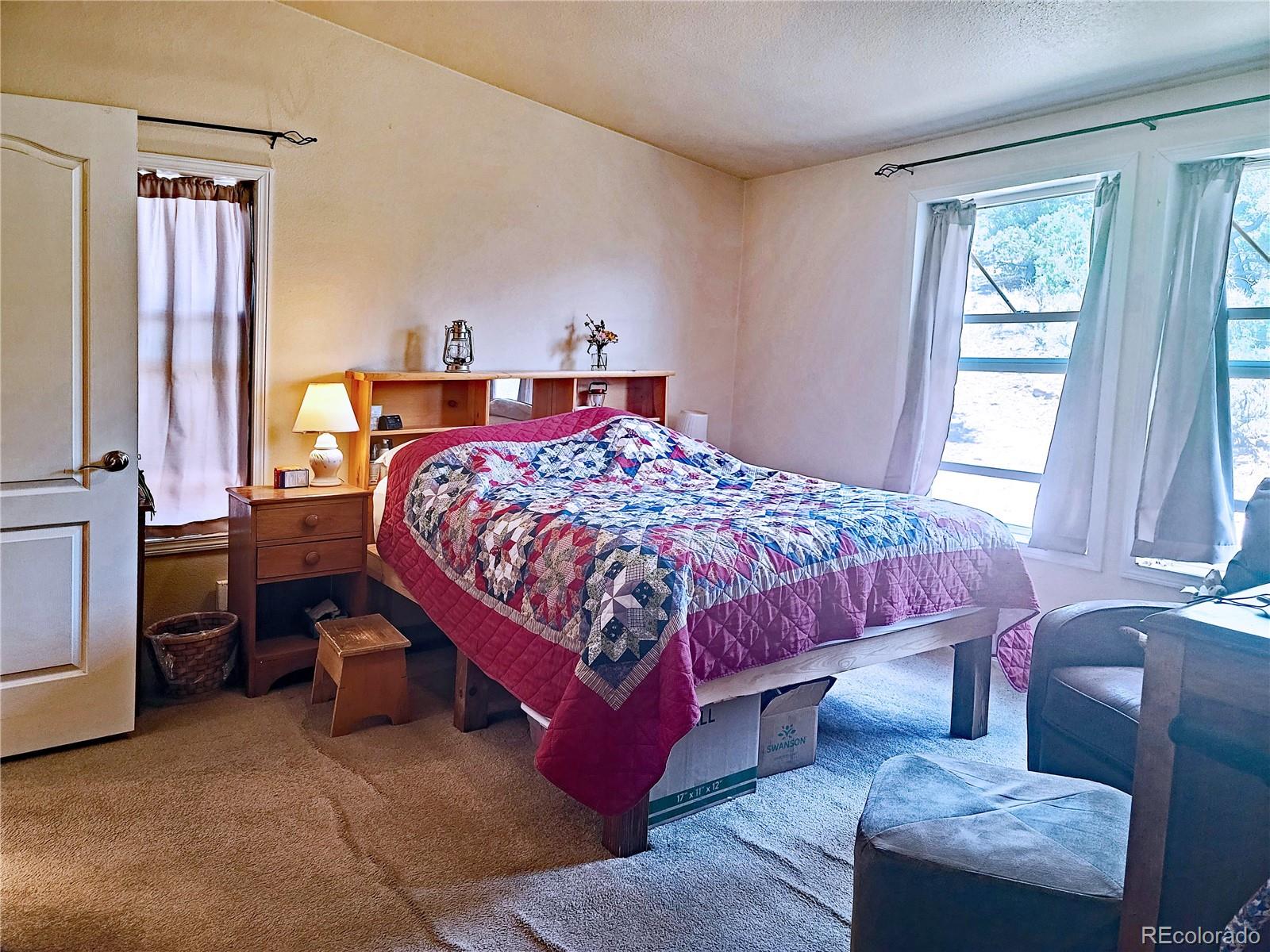 2252 White Tail Road, Unit 2 San Luis, CO 81152 - Photo 14 of 44 a bed sitting in a bedroom next to a window