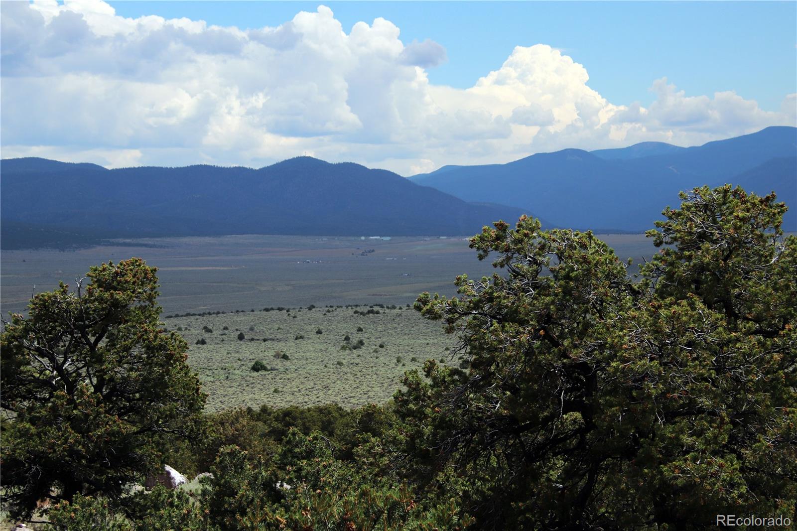 2252 White Tail Road, Unit 2 San Luis, CO 81152 - Photo 24 of 44 a view of a lake with mountains in the background