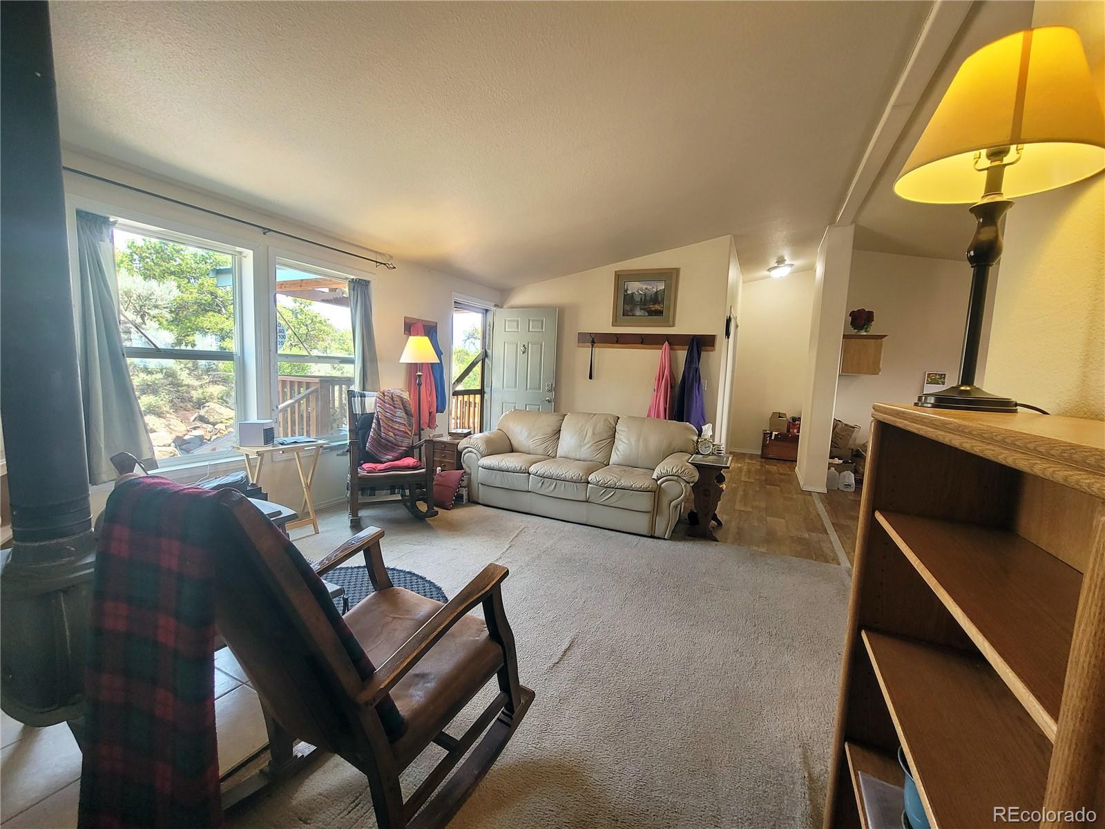 2252 White Tail Road, Unit 2 San Luis, CO 81152 - Photo 6 of 44 a living room with furniture and a lamp