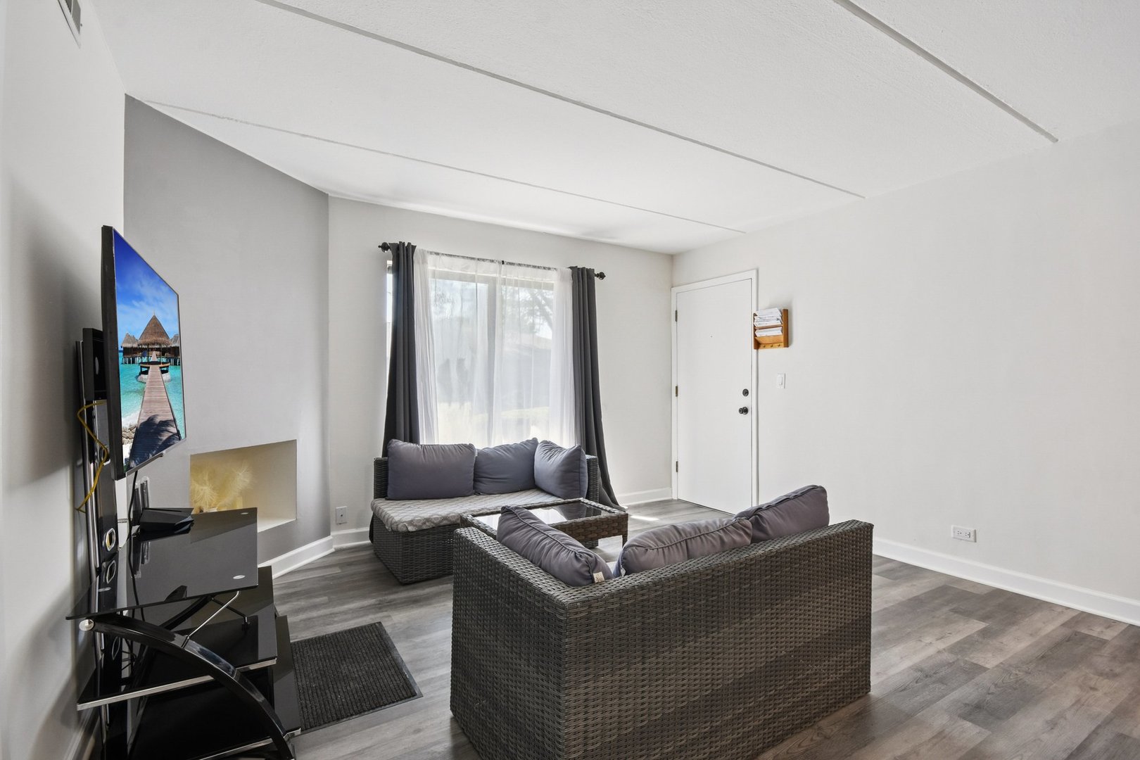 1751 South Washington Street, Unit 1 Naperville, IL 60565 - Photo 2 of 16 a living room with furniture and a flat screen tv