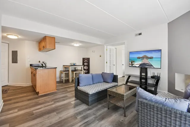 a living room with furniture and wooden floor
