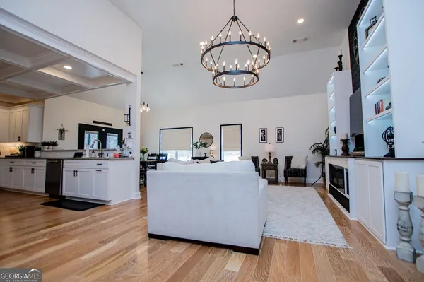 a view of living room and kitchen with wooden floor