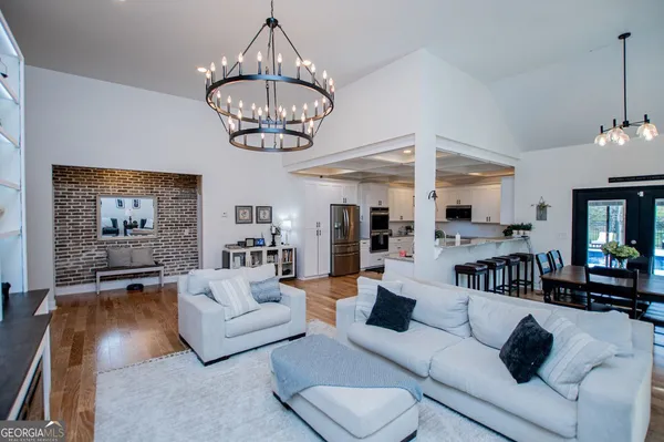 a living room with furniture chandelier and a chandelier