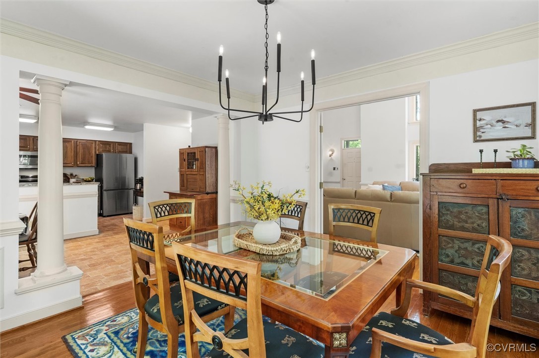 6000 Lansgate Road Midlothian, VA 23112 - Photo 18 of 49 a dining room with furniture a chandelier and wooden floor