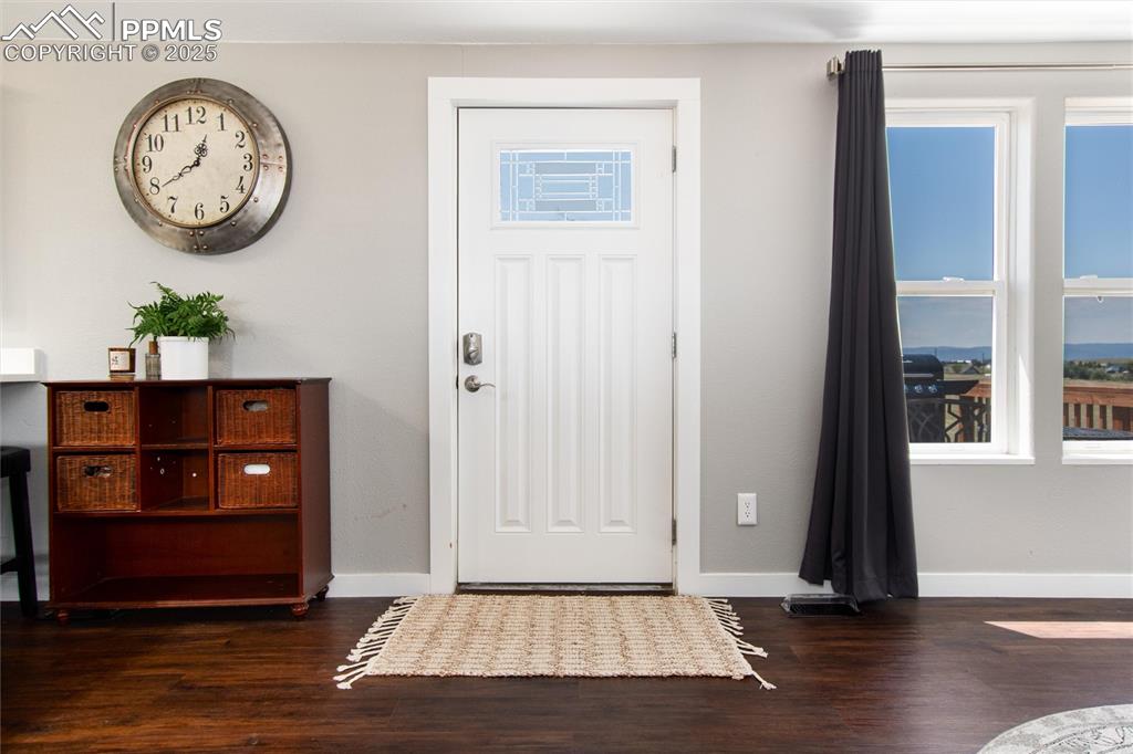 11100 Haskel Creek Road Larkspur, CO 80118 - Photo 11 of 49 a view of a hallway with wooden floor