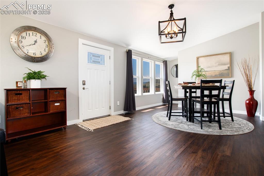 11100 Haskel Creek Road Larkspur, CO 80118 - Photo 12 of 49 a view of a dining room with furniture and wooden floor