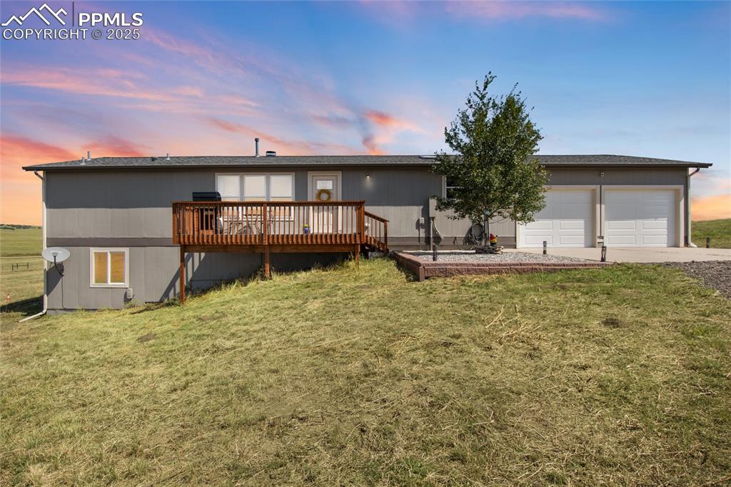 11100 Haskel Creek Road Larkspur, CO 80118 - Photo 2 of 49 a front view of a house with a yard