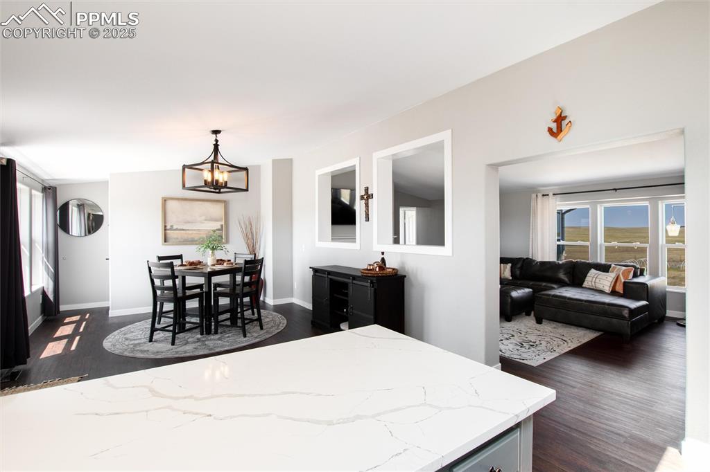 11100 Haskel Creek Road Larkspur, CO 80118 - Photo 21 of 49 a living room with furniture a flat screen tv and wooden floor