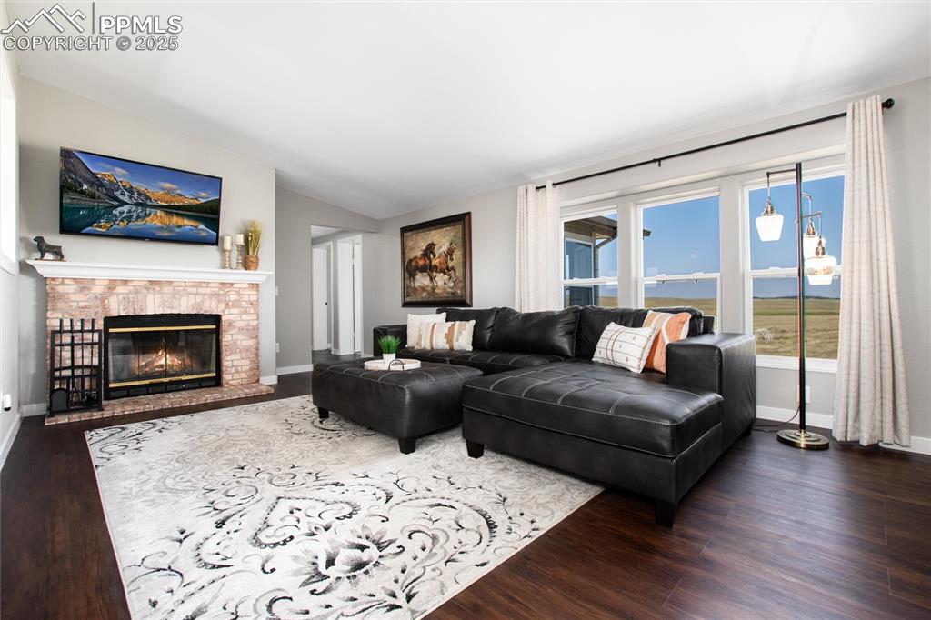 11100 Haskel Creek Road Larkspur, CO 80118 - Photo 22 of 49 a living room with furniture and a fireplace
