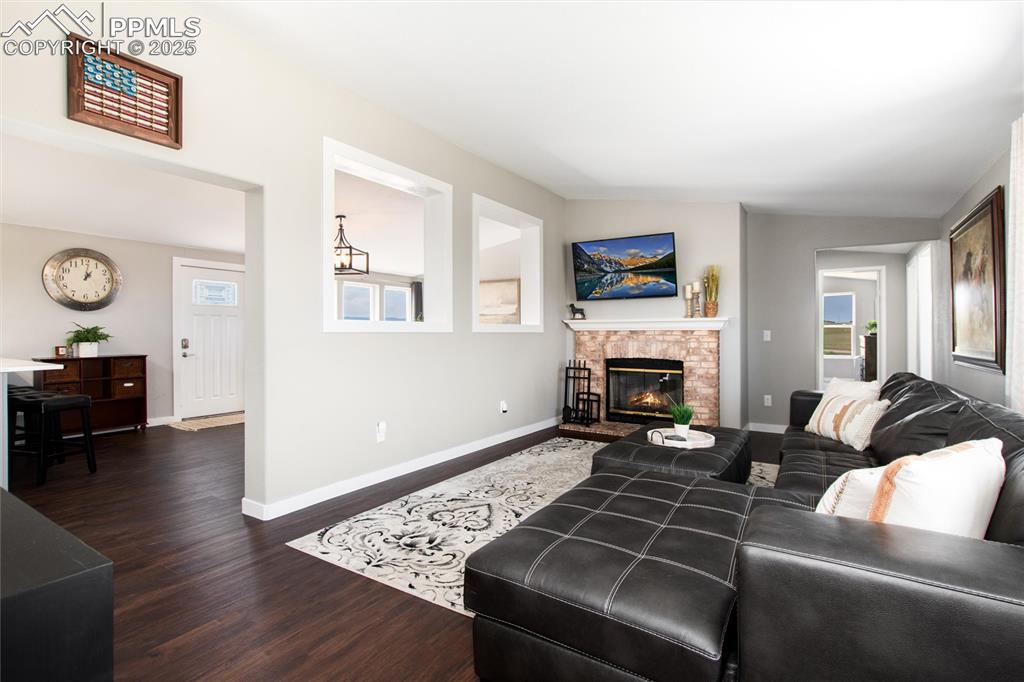 11100 Haskel Creek Road Larkspur, CO 80118 - Photo 23 of 49 a living room with furniture and a fireplace