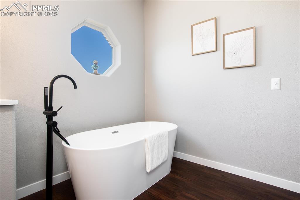 11100 Haskel Creek Road Larkspur, CO 80118 - Photo 30 of 49 a white bath tub sitting in a bathroom