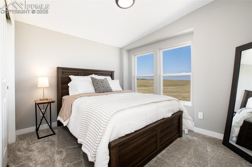 11100 Haskel Creek Road Larkspur, CO 80118 - Photo 32 of 49 a bed sitting in a bedroom next to a window