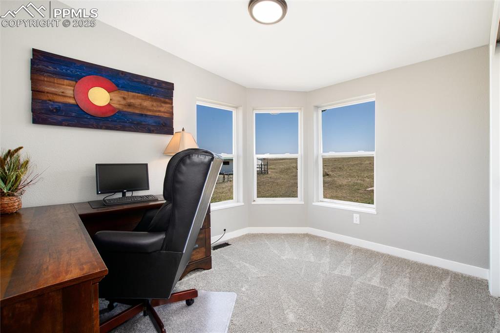 11100 Haskel Creek Road Larkspur, CO 80118 - Photo 33 of 49 a workspace with furniture and window