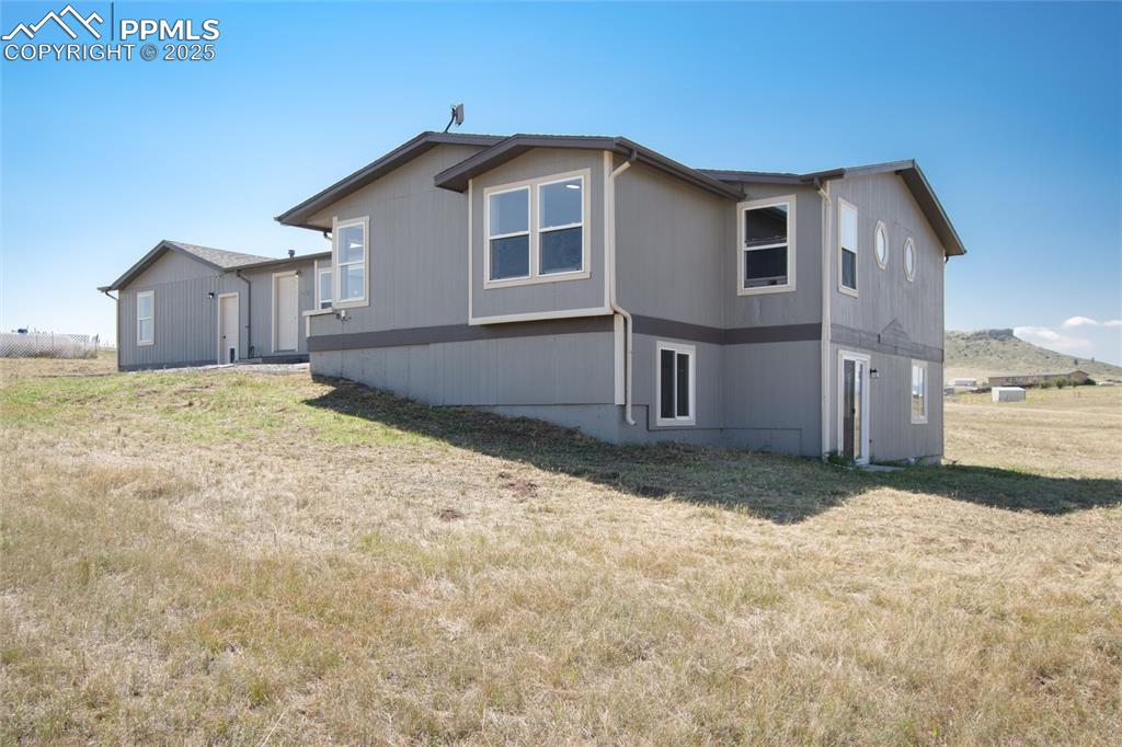 11100 Haskel Creek Road Larkspur, CO 80118 - Photo 7 of 49 a view of a house with a yard
