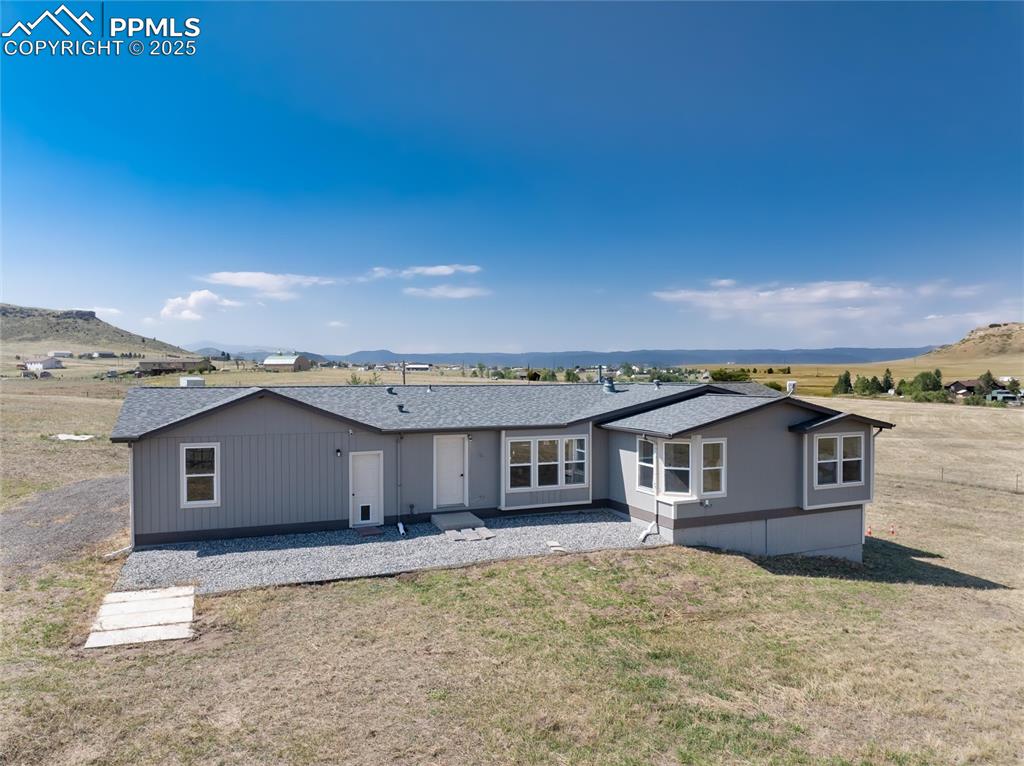 11100 Haskel Creek Road Larkspur, CO 80118 - Photo 8 of 49 a view of a house with a backyard