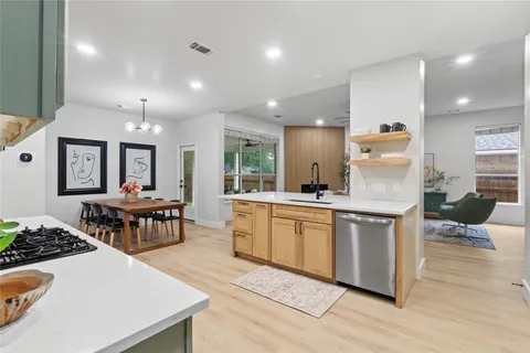 a view of a dining room with furniture and a kitchen