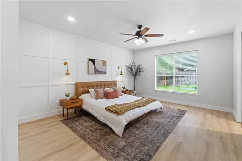 a view of a hallway with wooden floor and door