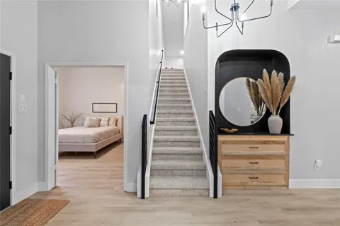 a bedroom with a bed and painting on the wall