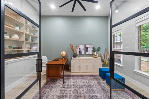 a living room with furniture a flat screen tv and a window