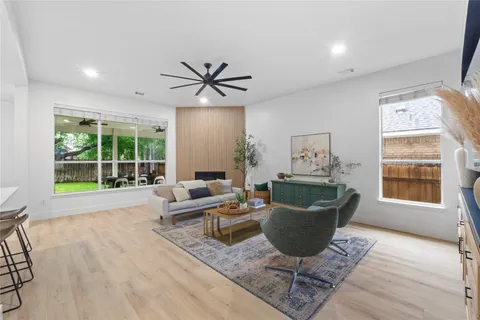 a kitchen with a dining table chairs and cabinets