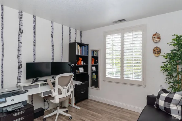 a bedroom with a bed and a painting on the wall