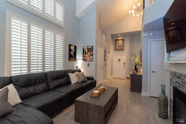a living room with furniture a flat screen tv and a window