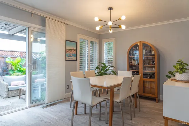 a view of a dining room with furniture and chandelier