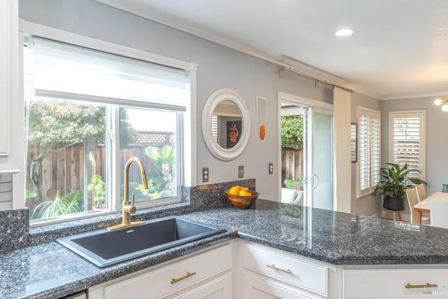 a kitchen with a sink and a large window