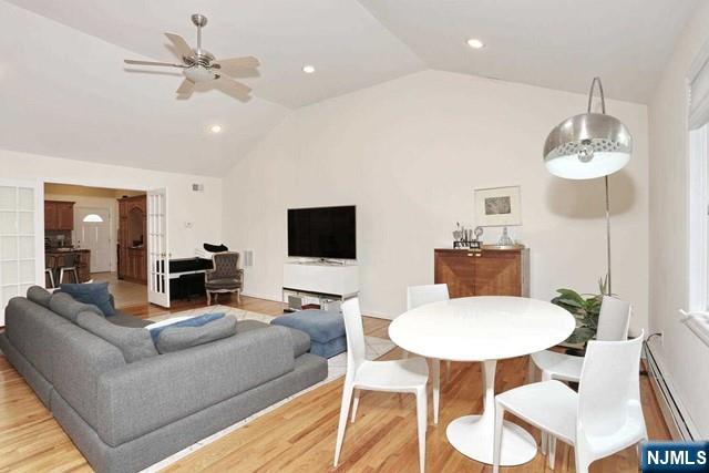 84 12th Street Cresskill, NJ 07626 - Photo 14 of 45 a living room with furniture a chandelier and a flat screen tv
