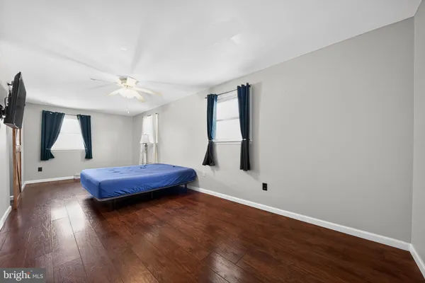 a bedroom with a bed window and a ceiling fan