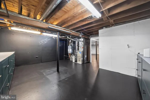 an empty room with wooden floor and garage