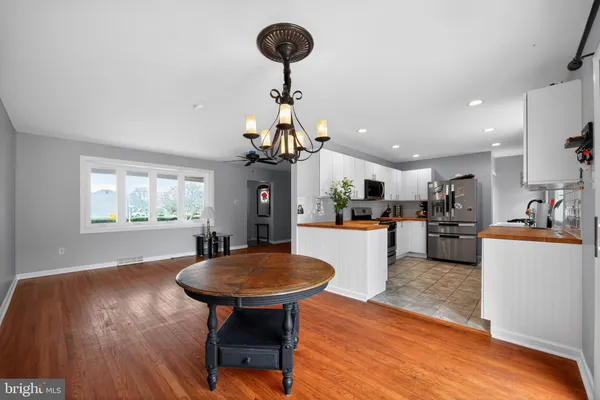 a kitchen with stainless steel appliances granite countertop a sink and stove top oven