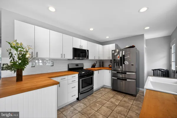 a kitchen with stainless steel appliances granite countertop a sink and cabinets