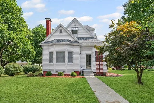 a front view of a house with a garden