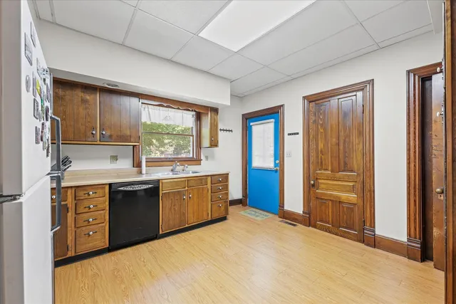 a large kitchen with granite countertop a sink stainless steel appliances and cabinets